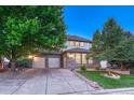 Attractive two-story home with a stone facade and a spacious driveway at 12350 Turquoise Terrace St, Castle Pines, CO 80108