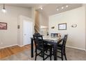 A cozy carpeted dining area, enhanced by natural light and a stairway nearby at 1018 Mulberry Ln, Highlands Ranch, CO 80129