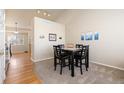 Cozy dining area with high ceilings and stylish black table set for four at 1018 Mulberry Ln, Highlands Ranch, CO 80129
