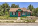 Charming home with a red front door and well-maintained green exterior at 4730 S Huron St, Englewood, CO 80110