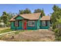 Charming home with a red front door and well-maintained green exterior at 4730 S Huron St, Englewood, CO 80110