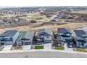 An aerial view shows the property and the community in a neighborhood setting with mountain views at 490 Silver Rock Trl, Castle Rock, CO 80104