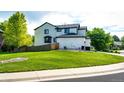Spacious backyard featuring a lush green lawn and mature trees, perfect for outdoor activities and relaxation at 10890 Willow Reed West Cir, Parker, CO 80134