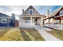 Charming two-story home with inviting front porch and well-maintained front lawn at 3825 Tejon St, Denver, CO 80211