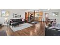 Open-concept living room with hardwood floors and black leather seating at 60 Yarrow St, Lakewood, CO 80226