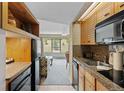 Well-equipped kitchen with wood cabinets, granite countertops, and stainless steel appliances at 640 Village Rd # 4220, Breckenridge, CO 80424