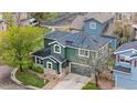 Aerial view of a green home with solar panels, surrounded by well-maintained landscaping and neighboring houses at 2119 W 101St Cir, Thornton, CO 80260