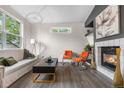 Bright living room featuring a fireplace, modern decor, and ample natural light at 2119 W 101St Cir, Thornton, CO 80260