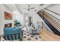 Bright living room showcases modern design with a fireplace, stylish seating, and an open staircase at 964 Quitman St, Denver, CO 80204
