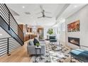 Open-concept design features hardwood floors, modern decor, and a kitchen with stainless steel appliances at 964 Quitman St, Denver, CO 80204