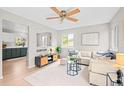 Cozy living room with modern decor, plush seating, and an open view into the dining area at 6183 Xavier St, Arvada, CO 80003