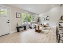 Bright living room with hardwood floors, modern furnishings, and large windows at 3793 S Sebring Ct, Denver, CO 80237
