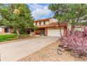 Lovely two-story home showcasing an attached garage and well-maintained driveway at 18434 E Belleview Ln, Centennial, CO 80015