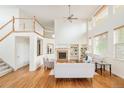 Bright living room boasts soaring ceilings, hardwood floors, a fireplace, and built-in shelving at 1477 Serene Dr, Erie, CO 80516