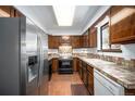 Traditional kitchen with wood cabinets, stainless steel appliances, tile countertops and a window at 9530 Aspen Ln, Conifer, CO 80433