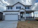 Charming two-story home with a two-car garage and a welcoming front porch at 2145 S Ider Way, Aurora, CO 80018