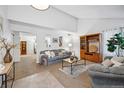 Bright and spacious living room with comfy sofas, a coffee table, and built-in shelving at 9292 W 98Th Way, Westminster, CO 80021