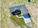 An aerial view of a single-story home with well-manicured lawn, deck, and driveway with an attached garage at 9 Timberlake Ct, Byers, CO 80103