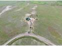 Aerial view of a single Gathering home in a rural setting, featuring a long drive way at 9 Timberlake Ct, Byers, CO 80103