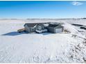 Spacious ranch home on a large lot with snow-covered landscape at 9 Timberlake Ct, Byers, CO 80103