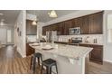 Spacious kitchen with dark cabinetry, a granite countertop island, and stainless steel appliances, perfect for cooking at 17620 Leisure Lake Dr, Monument, CO 80132