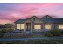 Charming single-story home with stone accents at sunset at 12625 Madison Way, Thornton, CO 80241