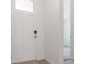 Bright entryway with a white front door with glass, white walls, and wood-look flooring at 564 Penn Rd, Elizabeth, CO 80107