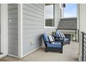 Inviting outdoor seating area with comfortable blue chairs and decorative pillows on front porch at 385 East St, Louisville, CO 80027