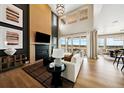 Elegant living room featuring a fireplace, high ceilings, large windows, and sliding glass doors at 8958 Whiteclover St, Littleton, CO 80125