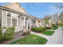 Well-manicured home exterior with a tidy lawn, inviting walkway, and a view of the porch at 8300 Fairmount Dr # M103, Denver, CO 80247