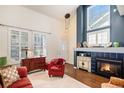 Inviting living room with fireplace, tall windows, and cozy furnishings, creating a warm atmosphere at 8300 Fairmount Dr # M103, Denver, CO 80247