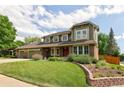 Attractive home showcasing mature trees, a brick facade and well maintained lawn at 1892 W Kettle Ave, Littleton, CO 80120