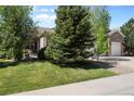 Well-maintained home with lush green lawn and mature trees at 744 Kryptonite Dr, Castle Rock, CO 80108