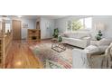 Comfortable living room featuring hardwood floors, couches and a colorful rug at 833 Applewood Dr, Lafayette, CO 80026