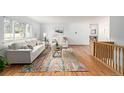 Bright living room featuring hardwood floors, couches and a colorful rug at 833 Applewood Dr, Lafayette, CO 80026