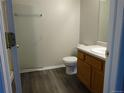 Bathroom with wood look flooring, wood vanity, and step in shower at 3271 E 103Rd Pl # 1308, Thornton, CO 80229