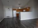 Open-concept kitchen with wooden cabinets, pendant lighting, and modern appliances at 3271 E 103Rd Pl # 1308, Thornton, CO 80229