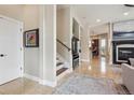Welcoming entryway featuring tile floors, stairs to the second level, and an open view to the living space at 7814 Inverness Blvd, Englewood, CO 80112