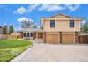 Attractive two-story home featuring a well-maintained lawn, double garage, and inviting curb appeal at 7285 S Yukon Ct, Littleton, CO 80128
