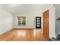 Bright living room with hardwood floors and a skylight at 7120 S Clay St, Littleton, CO 80120
