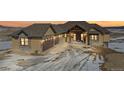 Stunning two-story house with a three-car garage at dusk at 5320 Dual Rey Pt, Sedalia, CO 80135