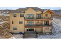 Back of house showing two-story deck and walkout basement at 5320 Dual Rey Pt, Sedalia, CO 80135