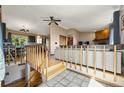 Stairway leads to the living room, dining area and kitchen at 8386 S Davco Dr, Morrison, CO 80465