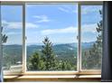 Expansive view through large window with bright sunlight and blue sky at 8386 S Davco Dr, Morrison, CO 80465