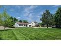 Expansive front yard featuring a well-maintained lawn and inviting curb appeal at 10297 W Crestone Mtn, Littleton, CO 80127
