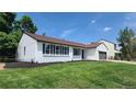 View of charming exterior with well-kept lawn, updated windows and dark wood trim at 10297 W Crestone Mtn, Littleton, CO 80127