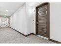 Hallway showcasing neutral colored carpet, clean architectural lines, and modern lighting fixtures at 485 Interlocken Blvd # 209, Broomfield, CO 80021