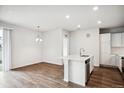 Bright, open concept room features an island kitchen and living space at 485 Interlocken Blvd # 209, Broomfield, CO 80021