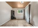 Cozy bedroom featuring hardwood floors, a window with natural light, and neutral color scheme at 1777 Main St, Georgetown, CO 80444