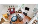 Bright living room with a high ceiling, wood floors, and cozy seating with a red front door at 1777 Main St, Georgetown, CO 80444